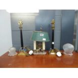 A pair of brass table lamps with Corinthian columns together with a 'twin-candle' desktop lamp and