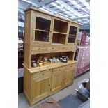 Modern oak wall unit with glazed doors and shelves over