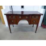 A George III mahogany crossbanded serpentine-fronted sideboard on tapering legs