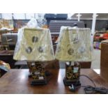 A pair of contemporary black and gilt glazed table lamps with floral shades