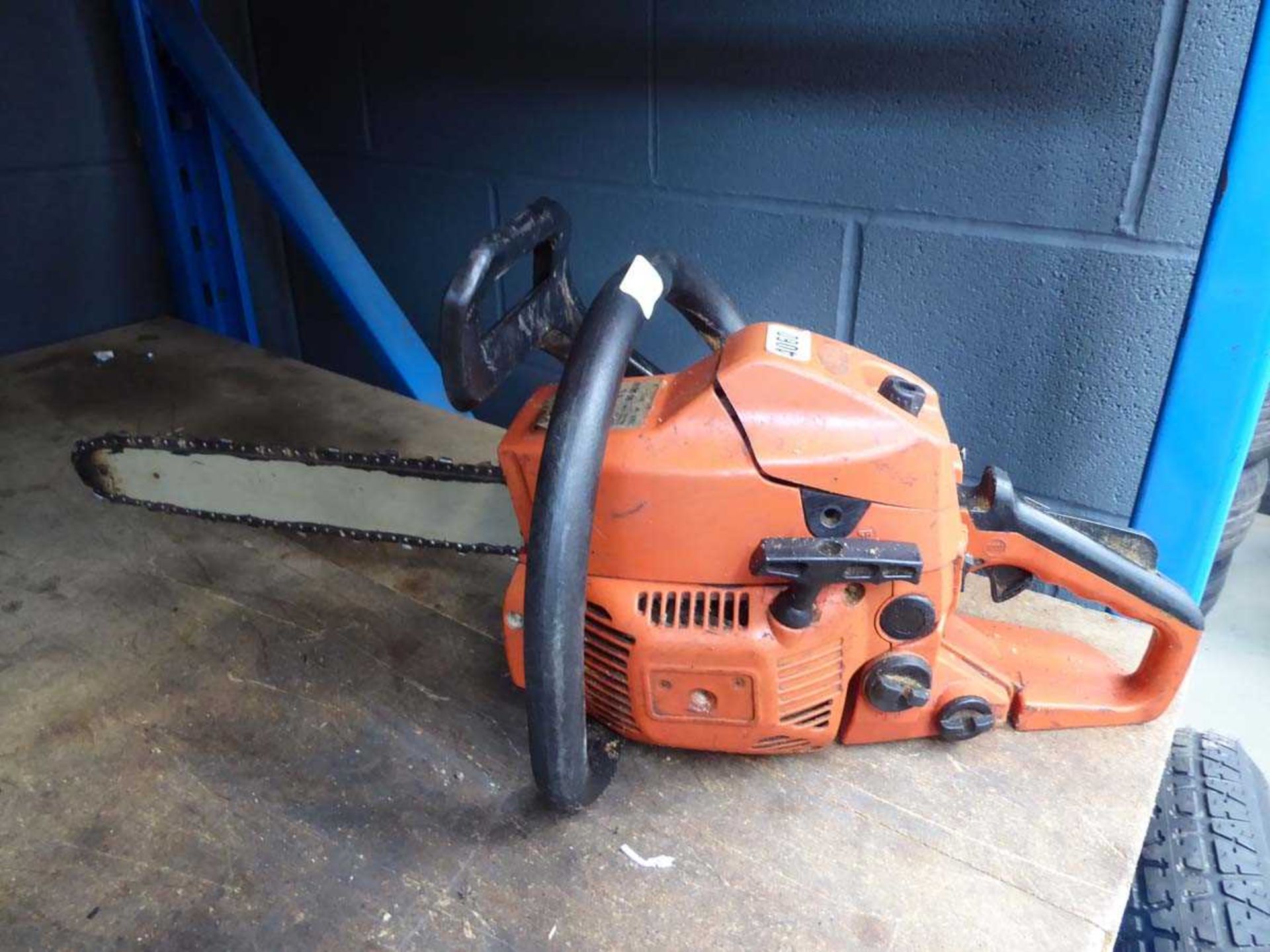 Orange petrol powered chainsaw