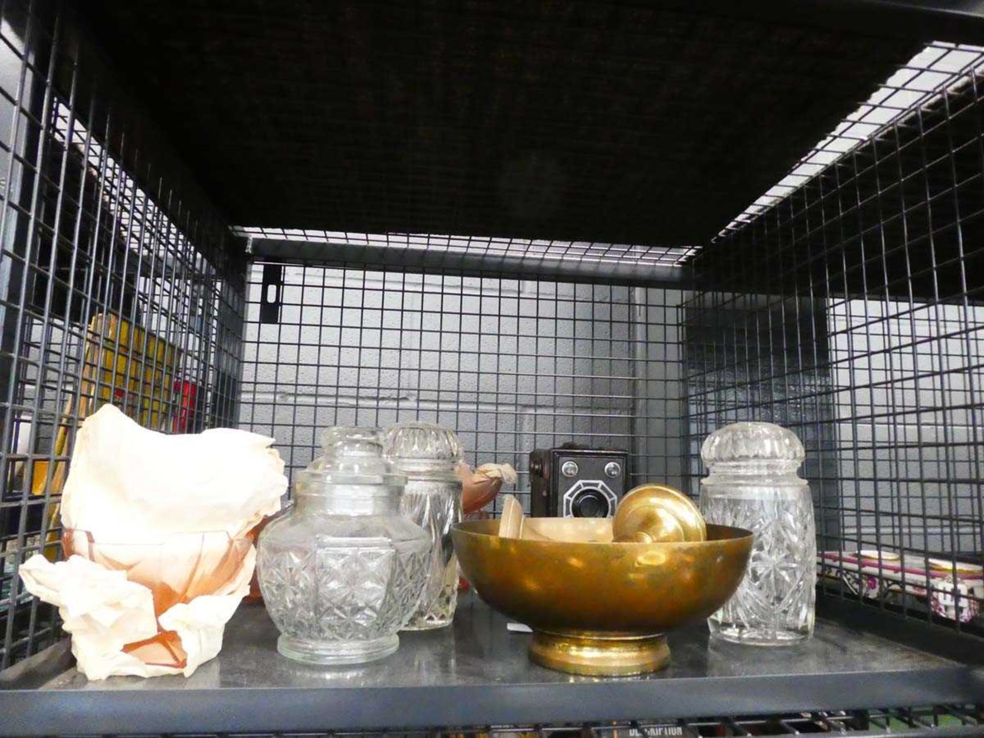 Cage containing a boxed Brownie camera, brass dish, candlesticks and lidded glass pots