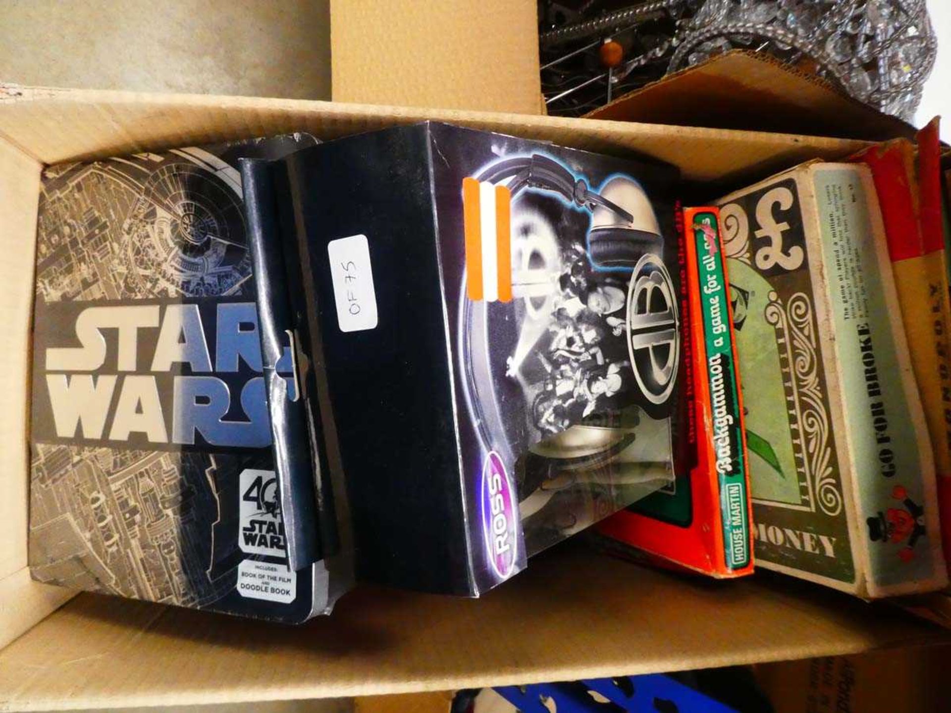 Box containing Star Wars tins, board games and headphones