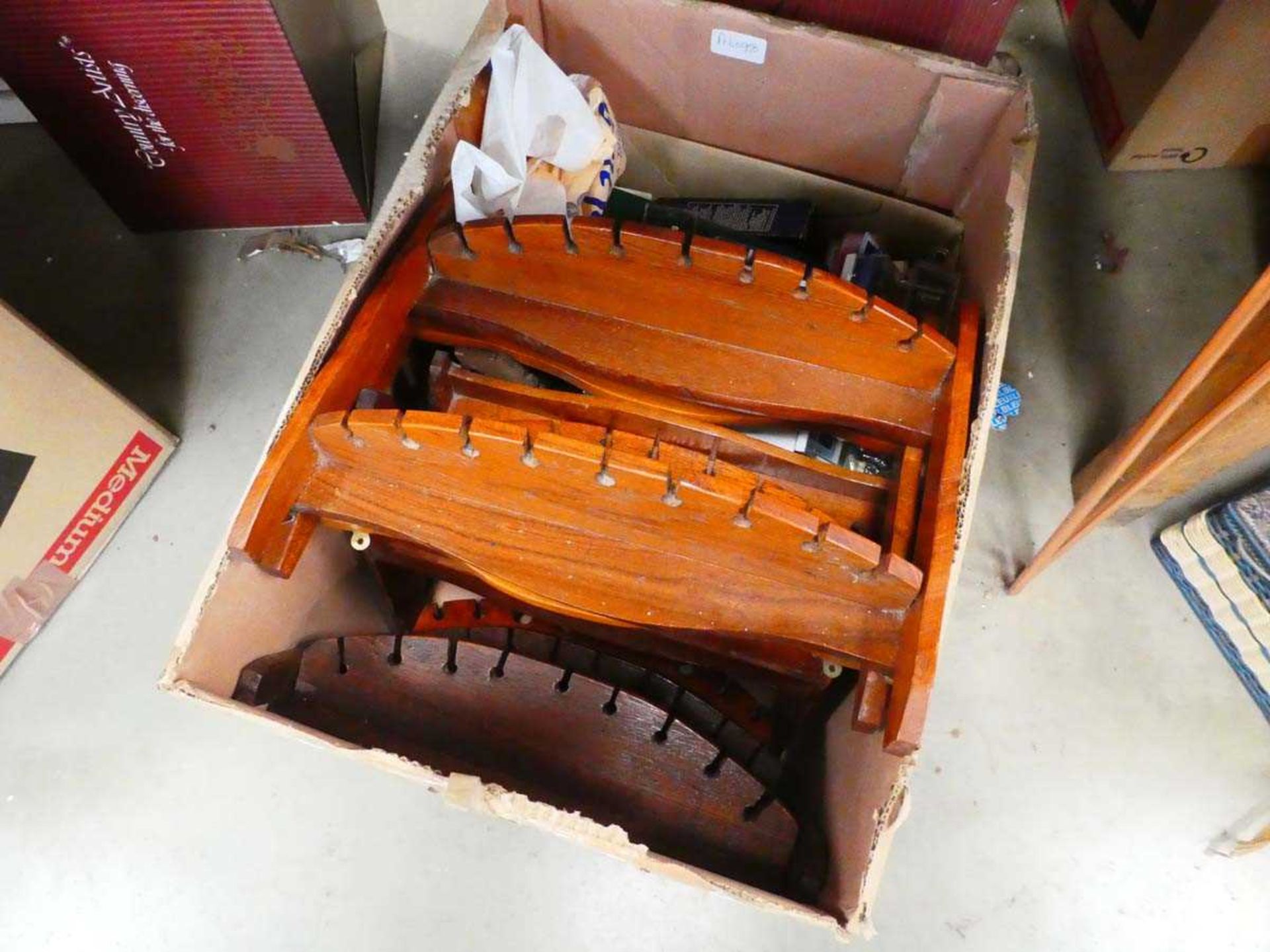 Box containing collection of souvenir spoons and racks