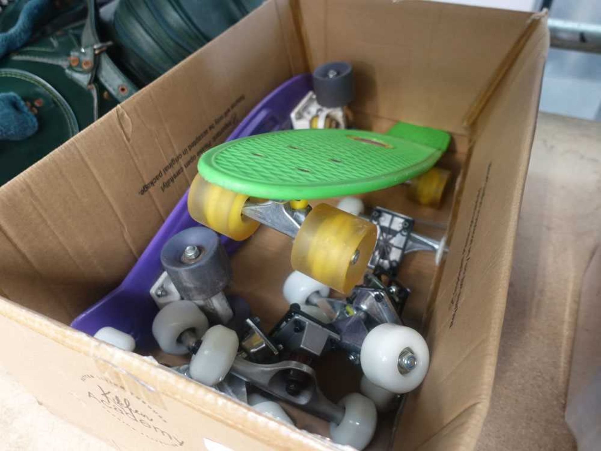2 plastic skateboards and quantity of skateboard wheels