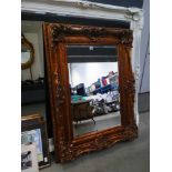 Rectangular bevelled mirror in decorative gilt frame