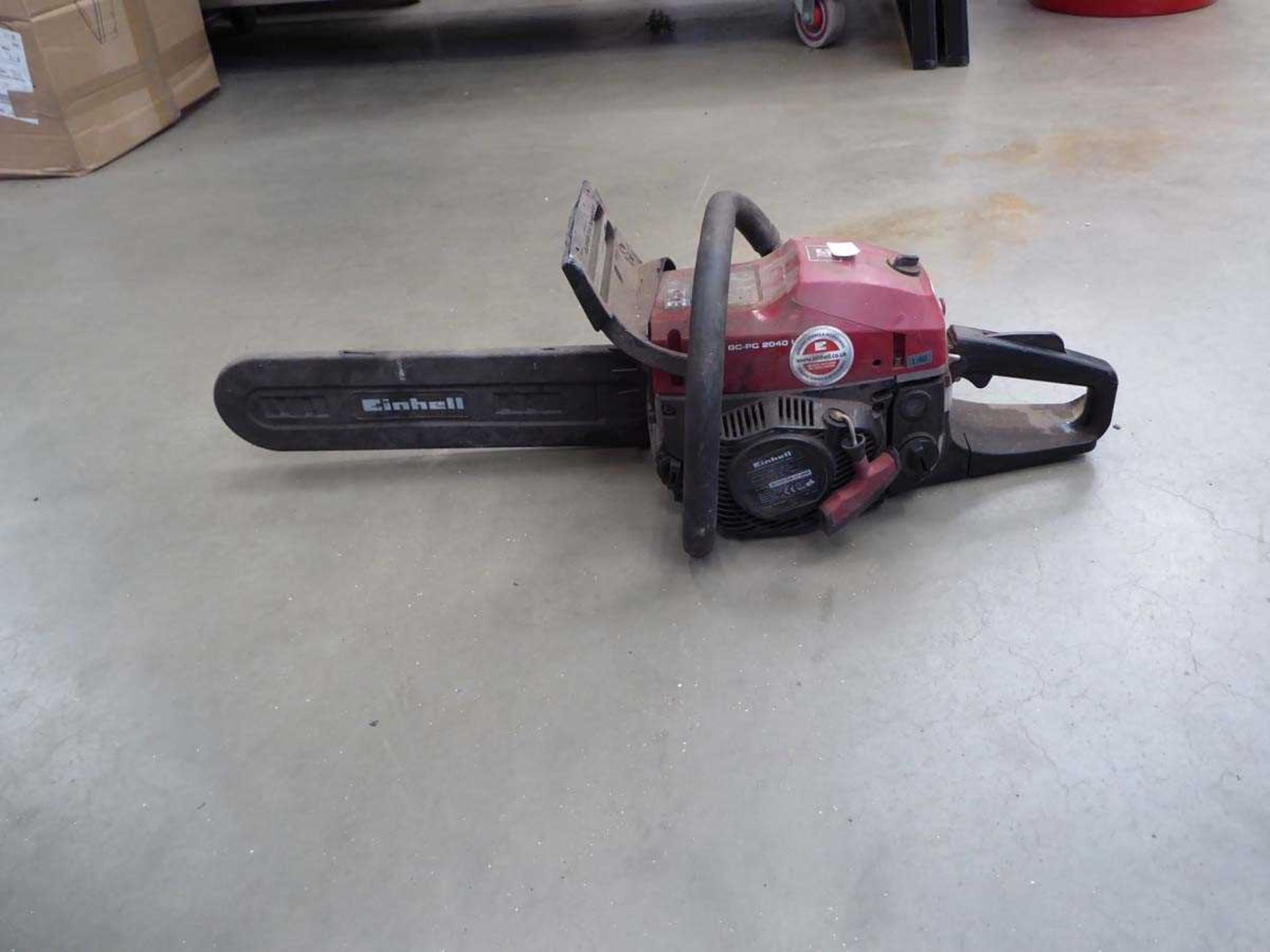 Red petrol powered chainsaw