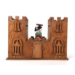 A Folk Art money box in the form of a castle, w. 22 cm