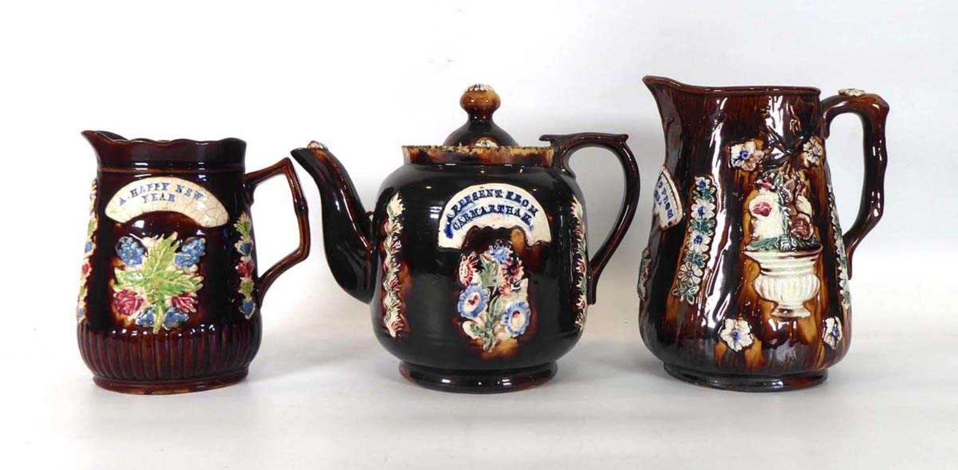 A bargeware teapot, typically decorated 'A Present from Carmarthan', h. 19 cm and similar two