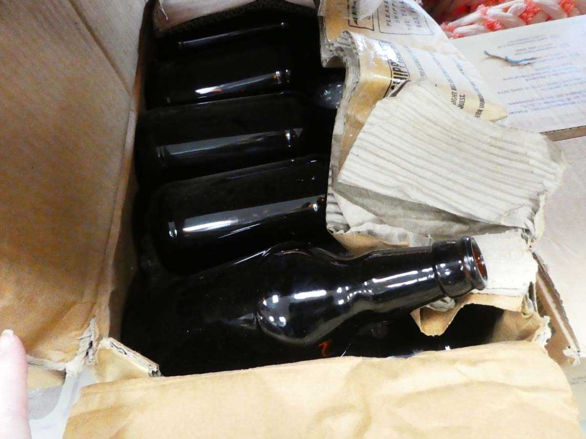2 boxes containing glass bottles