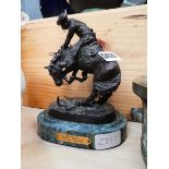 Metal figure of cowboy on horseback after Remington