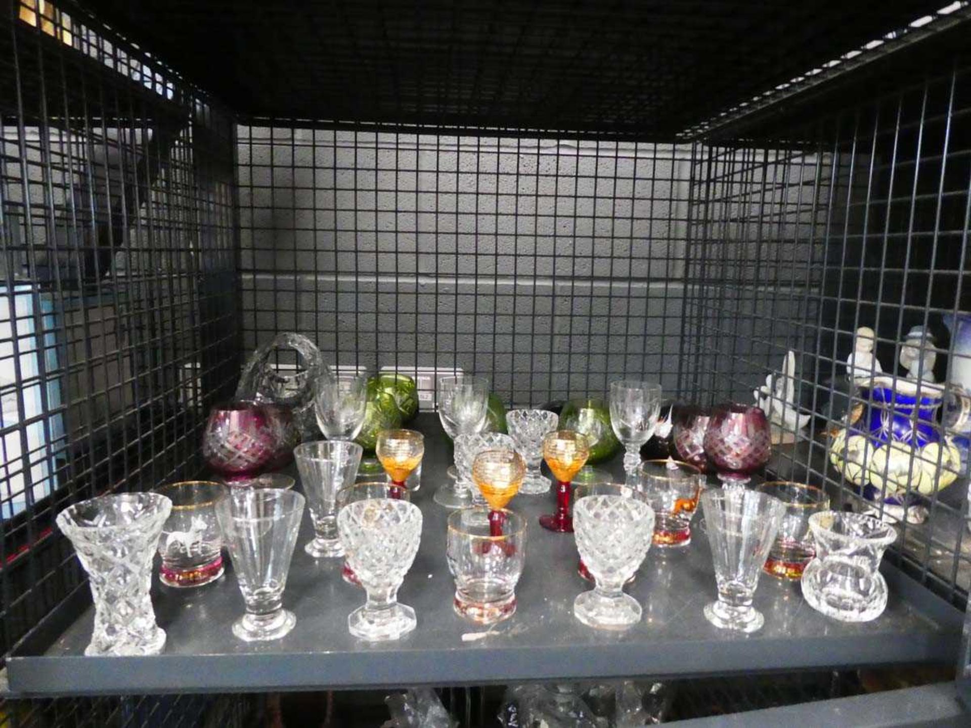 (24) Cage containing a quantity of sherry and shot glasses plus paperweights and a basket