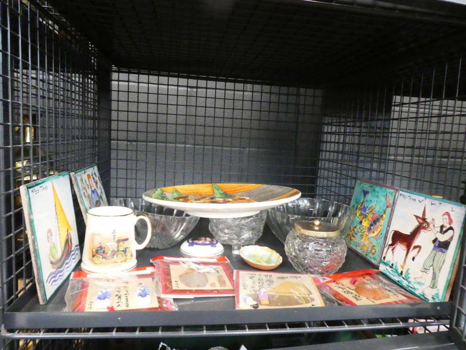 Cage containing character plate, glass bowls, tiles and china