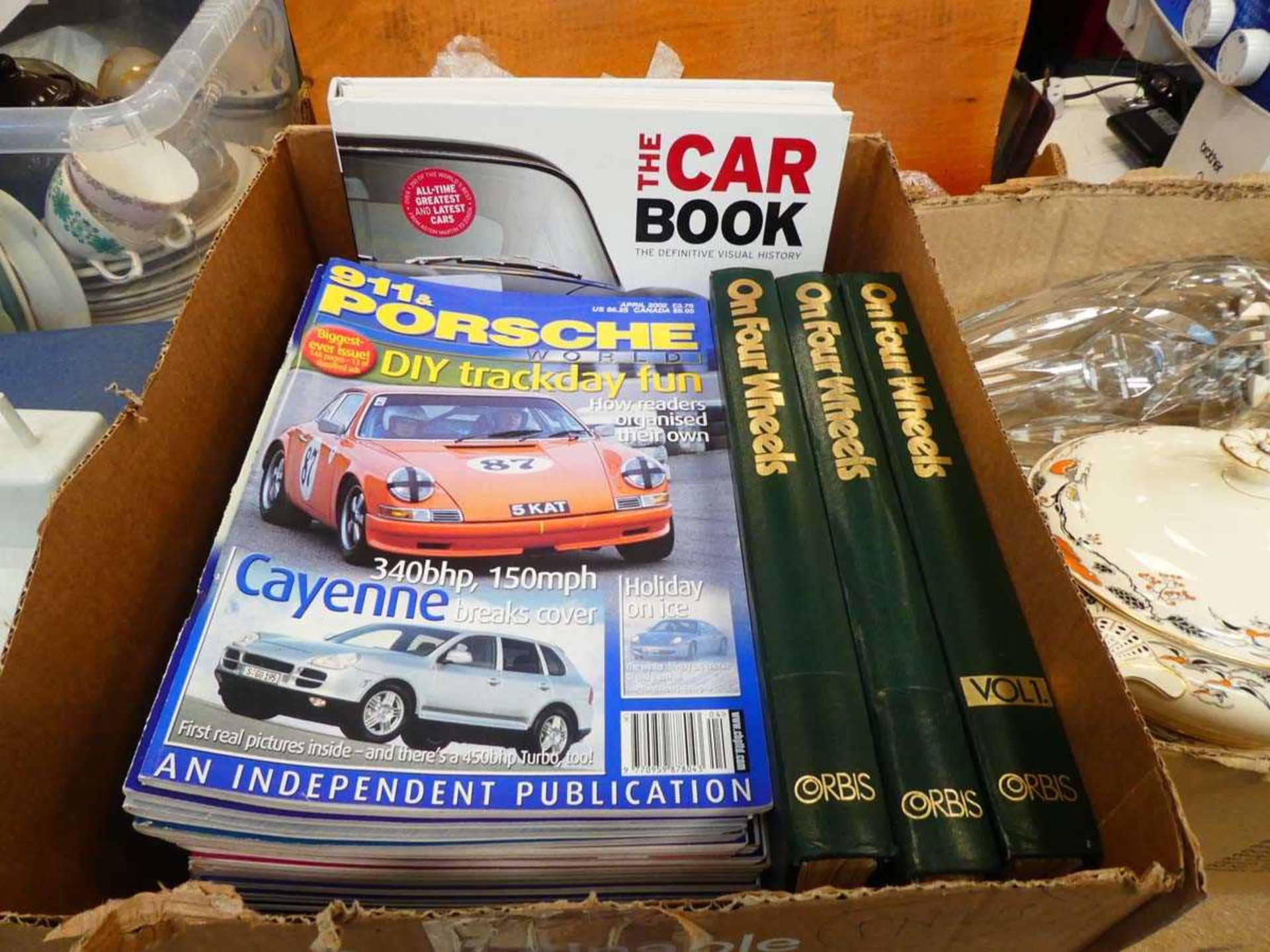 Box containing car magazines and books