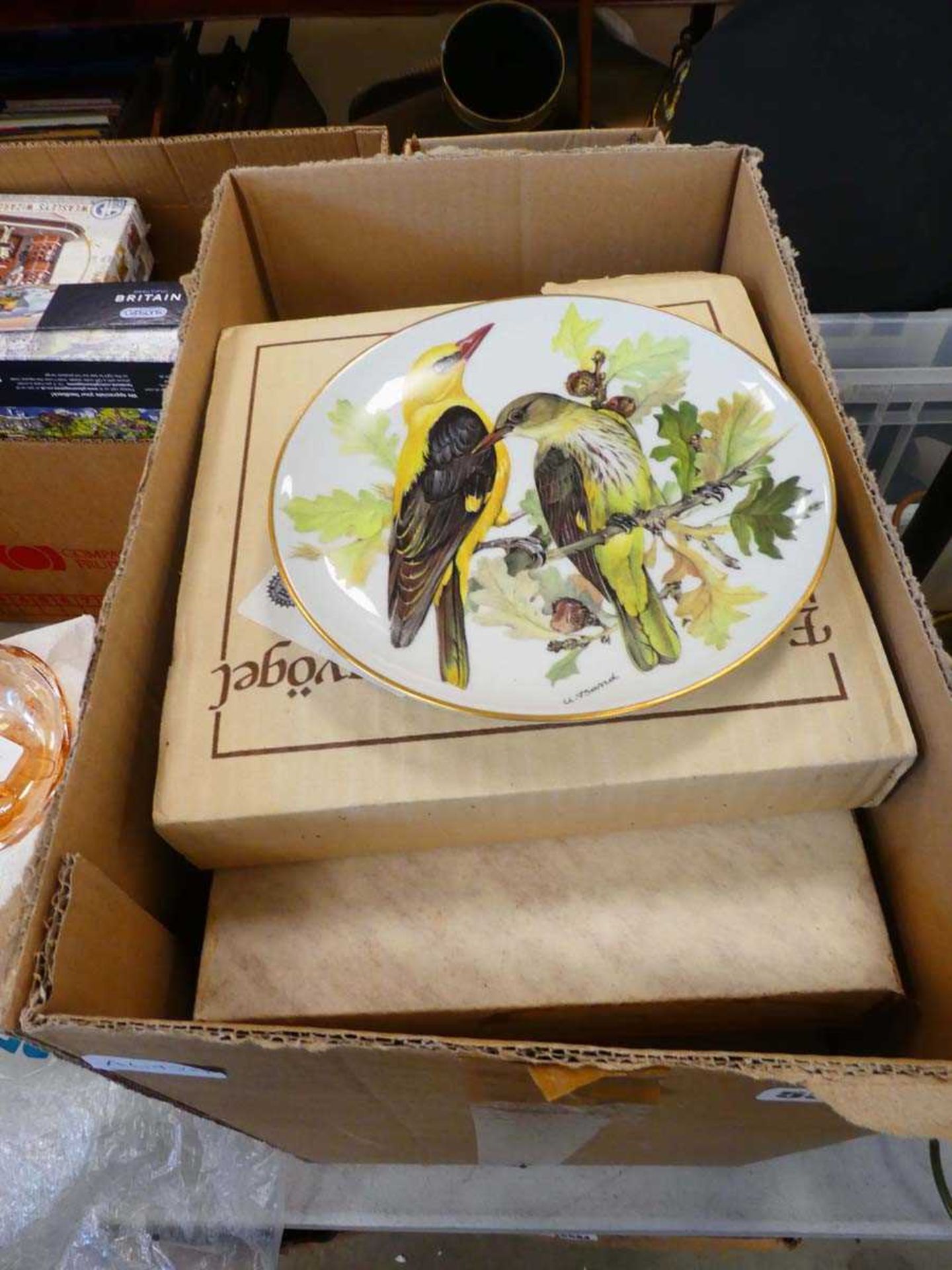 Box containing bird patterned collectors plates