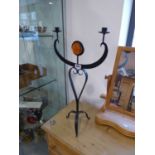 Modern twin branch wrought metal candlestick in form of figure