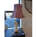 Oriental figurine table lamp base with brass stand and tapered pink shade