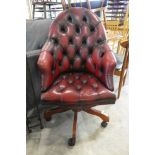 Swivel office chair on 5 star support upholstered in the red leather button back Chesterfield