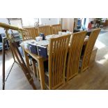 Modern light oak dining table with 6 matching high back black upholstered dining chairs