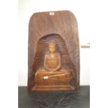 Oriental wood carving of a seated Buddha