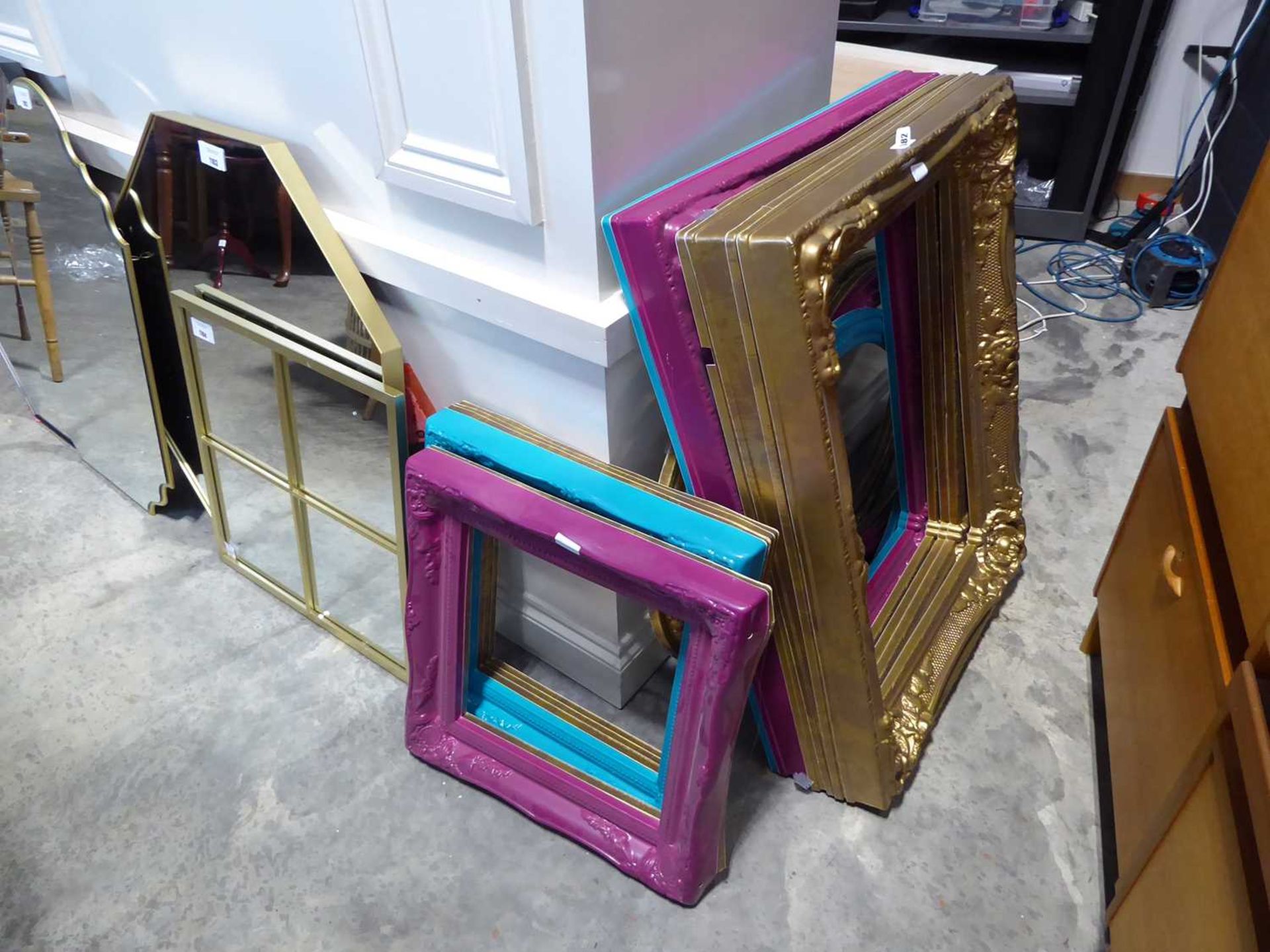 Large quantity of plastic picture frames in various shapes and sizes