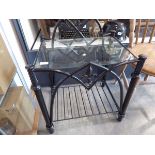 Wrought metal side table with glass surface and shelf beneath