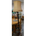 Dark wooden floor lamp with cream coloured shade