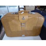 Tan Samsonite suitcase