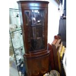 Reproduction mahogany bow fronted and glazed corner cabinet