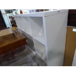 Modern white IKEA Kallax style pigeon hole shelf unit, together with a connected work desk and