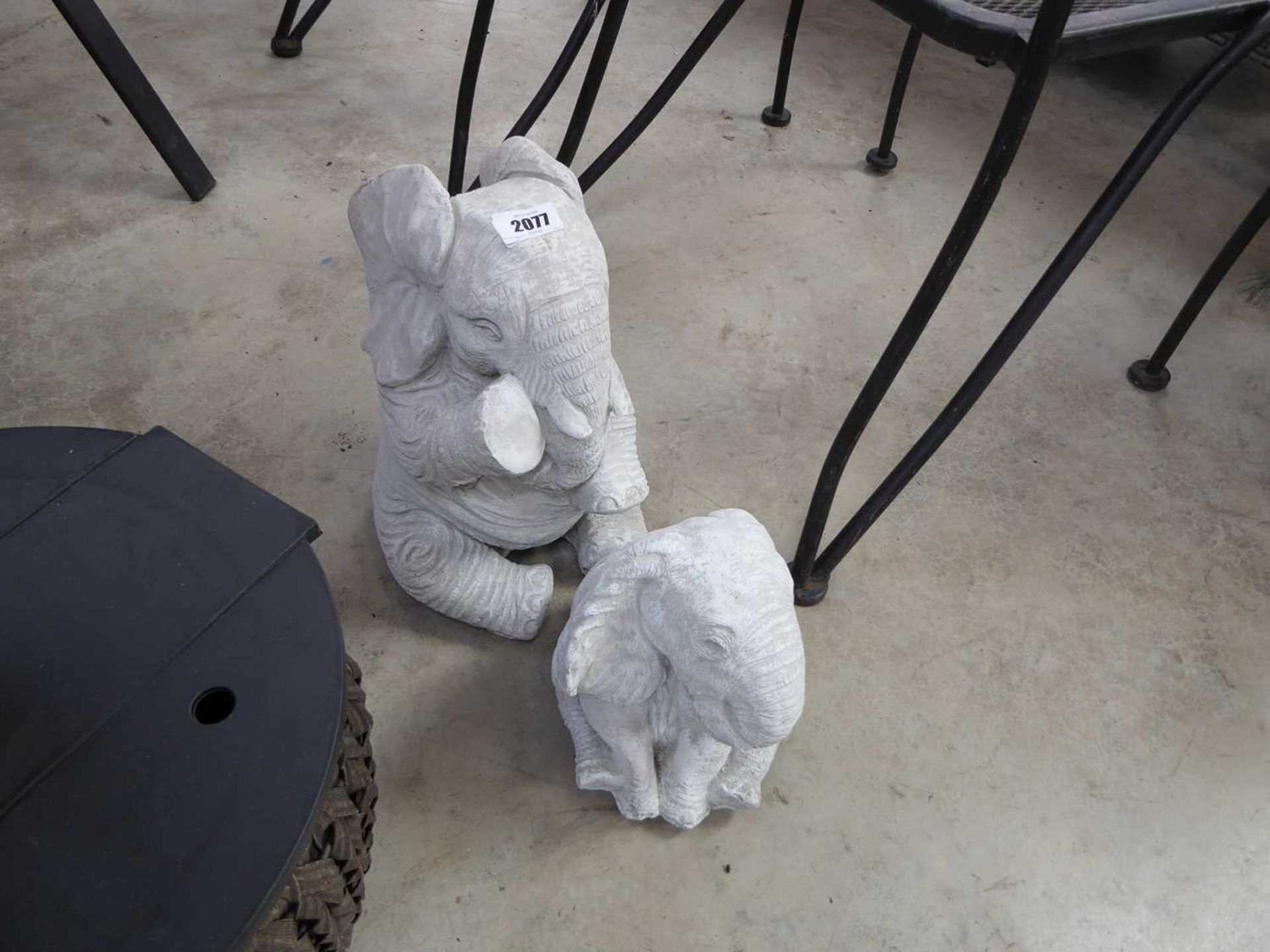 1 large and 1 small concrete sitting elephant