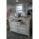 Modern curved fronted chest with rear bevelled mirror and an arrangement of 9 drawers