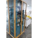 Modern light oak display cabinet with blue fitted interior shelving (100w x 54d x 215h cm.)