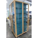 Modern light oak display cabinet with blue fitter interior shelving (100w x 54d x 215h cm.)