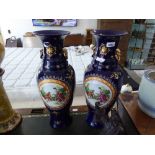 Pair of tall blue and gilt ceramic urns