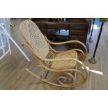 Thonet style bent wood rocking chair with cane seat and back