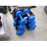 3 pairs of dumbbell weights on storage tree