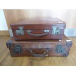2 brown leather suitcases