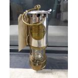 Miner's lamp in polished brass, manufactured by the Protector Lamp & Lighting Co. Ltd, Eccles