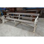 Long garden bench with white painted cast iron ends and central support