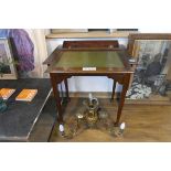 Dark oak writing table with hidden letter rack and ink wells beneath tooled leather sliding surface