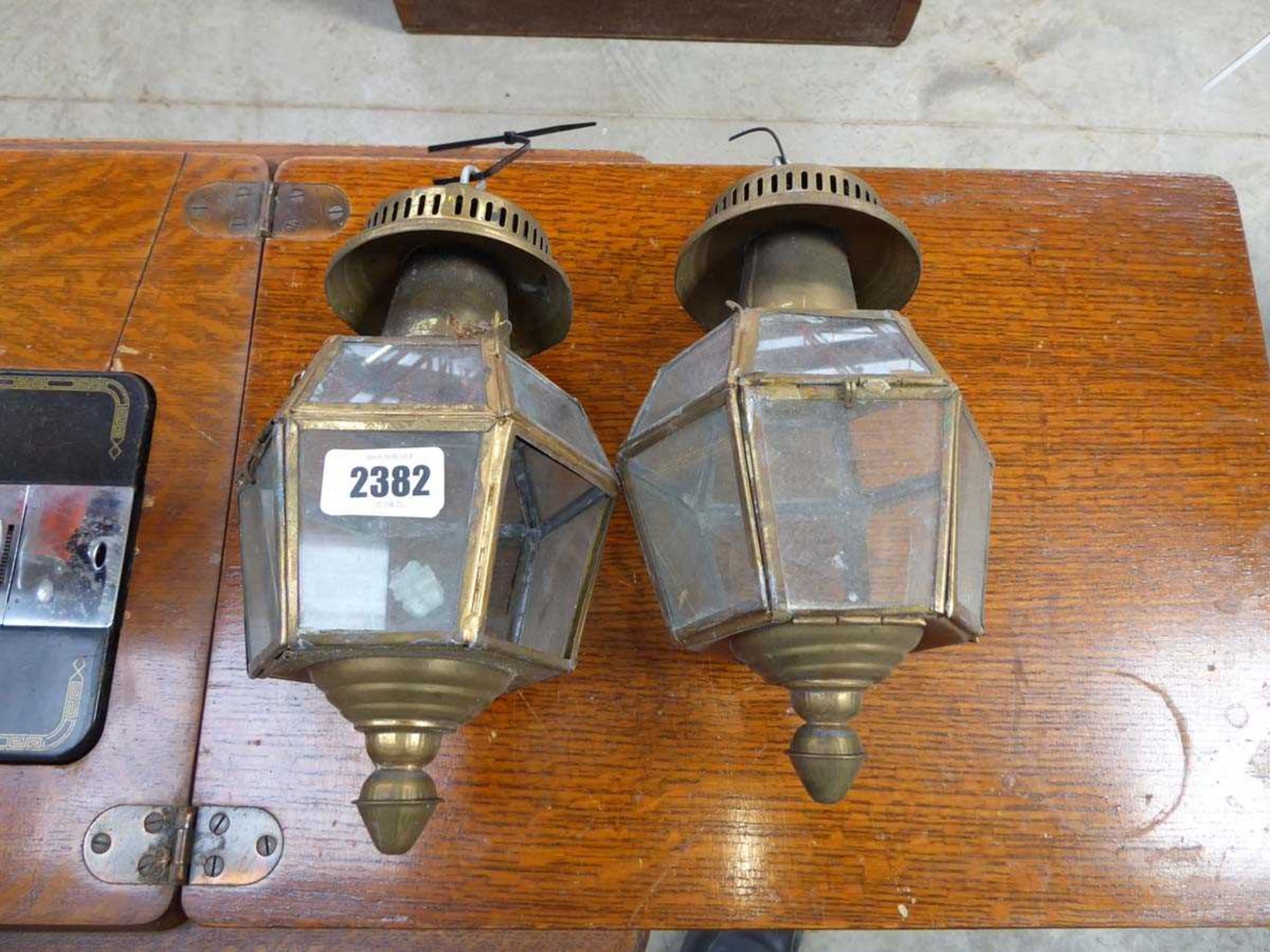 Pair of small brass hanging lantern light fittingsSignificant damage to glass with some missing