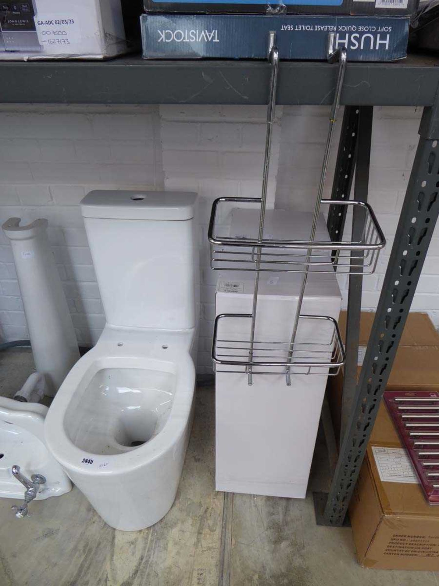 White ceramic WC with 2 boxed chrome shower caddies