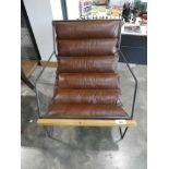 +VAT Metal framed easy chair with slung brown cushion and wooden trim