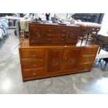 Oriental hard wood entertainment stand with 3 central drawers and 2 small cupboards