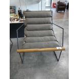 +VAT Metal framed easy chair with slung green cushion and wooden trim