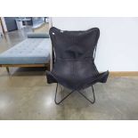 Black leather easy chair with metal supports