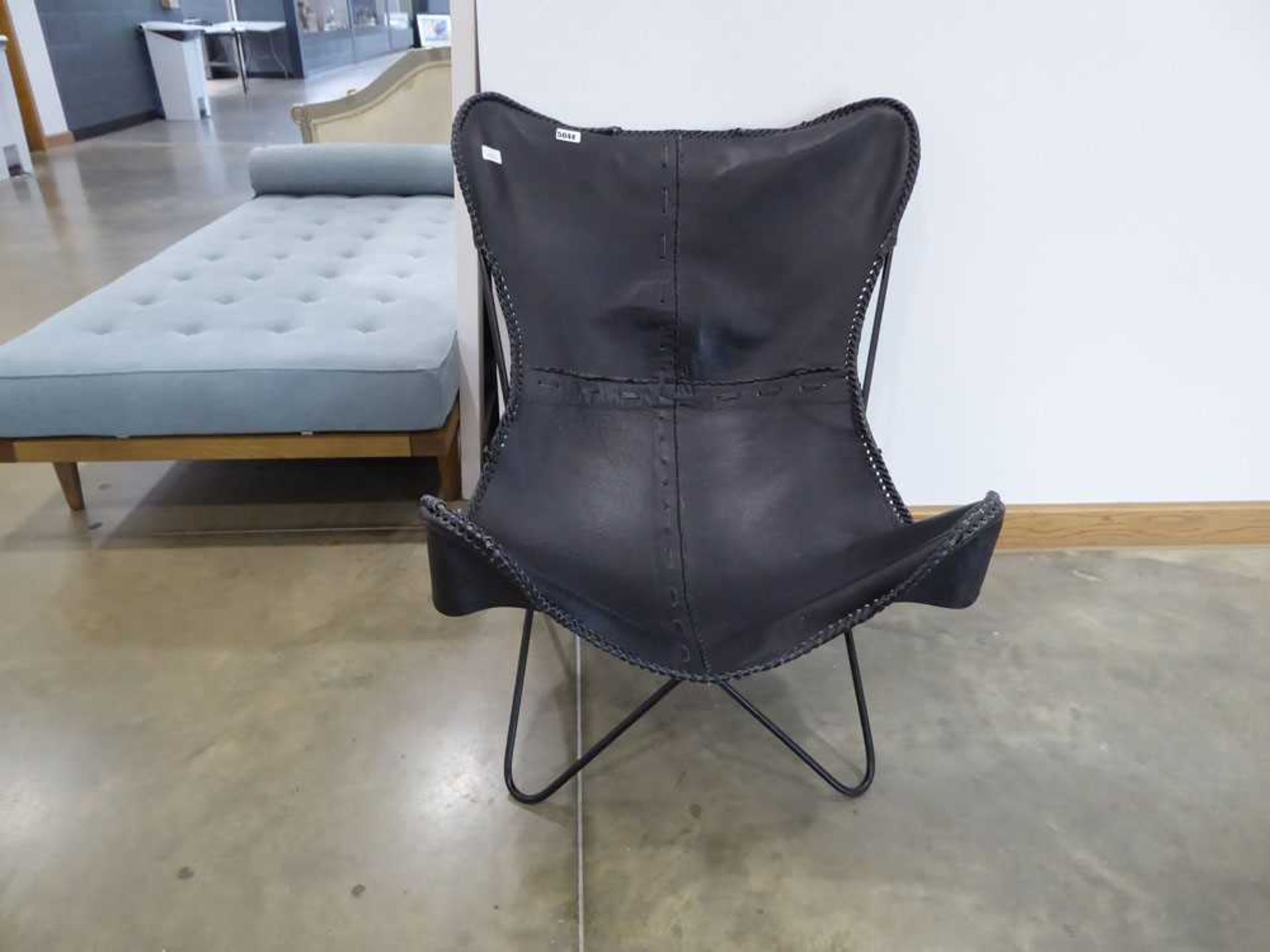 Black leather easy chair with metal supports