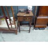 A reproduction beech 'rent' table, the surface with a round hole over a side drawer, on turned legs,