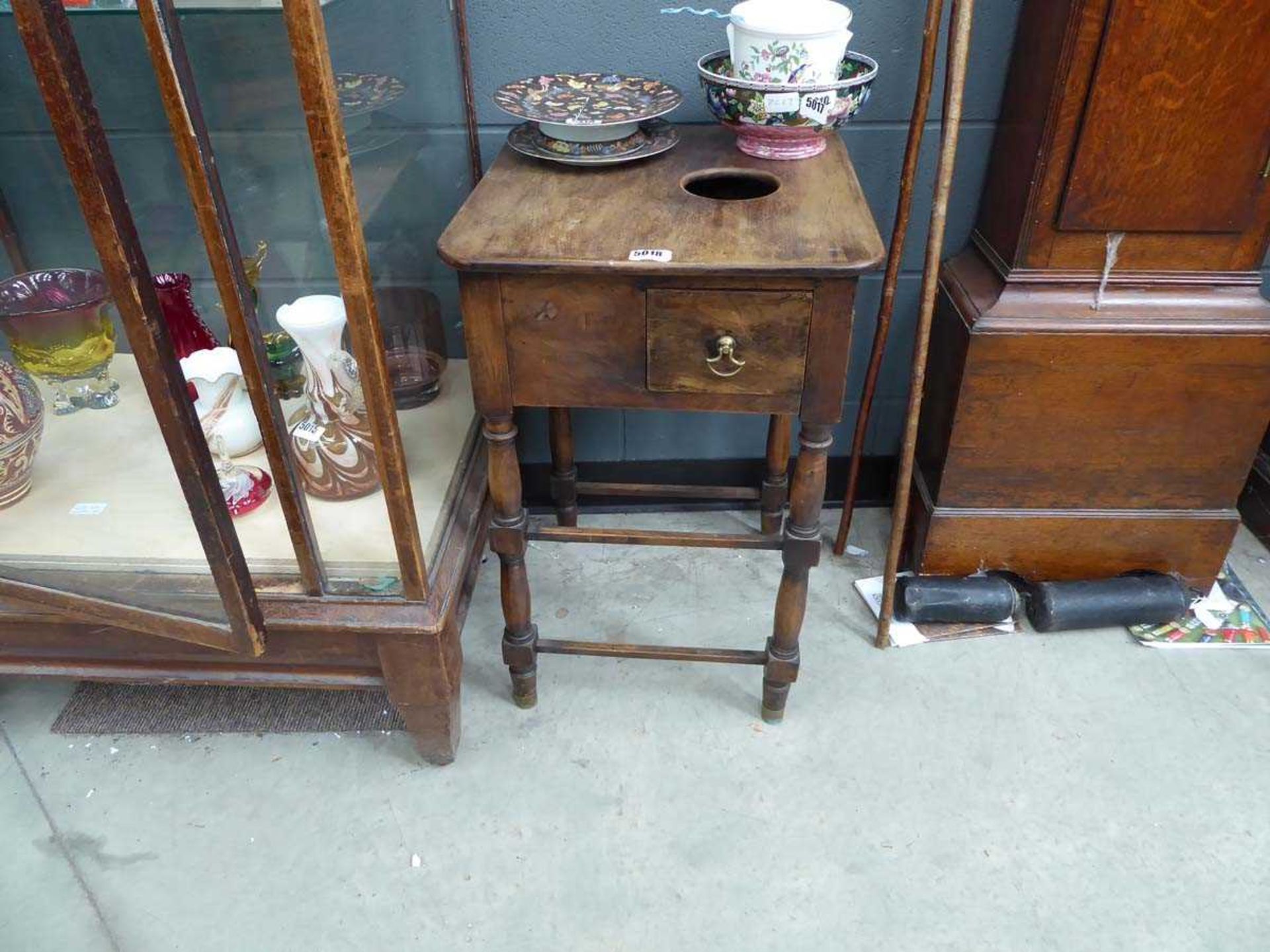 A reproduction beech 'rent' table, the surface with a round hole over a side drawer, on turned legs,